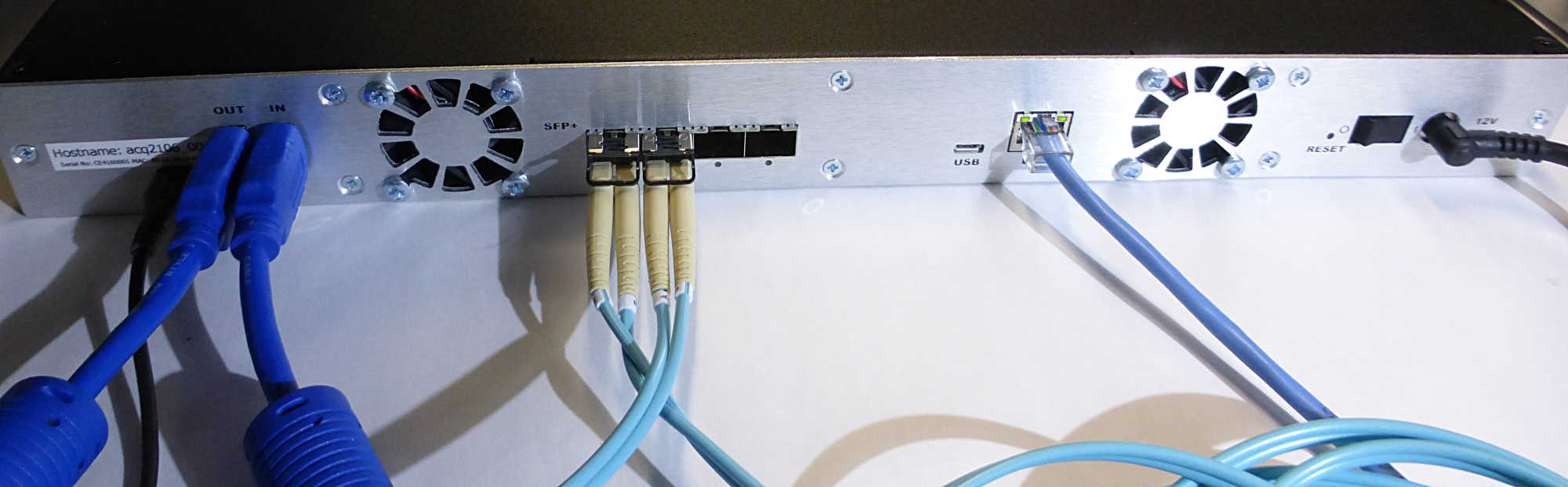 ACQ2106 rear panel showing 4 x SFP fiber-optic ports, SYNC cable and Ethernet.